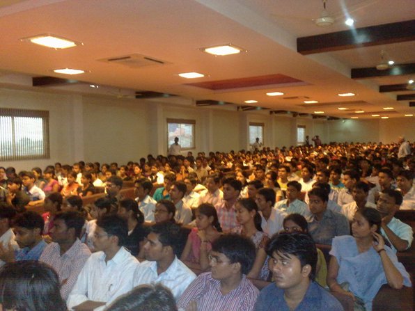 a large crowd of people sitting in a room