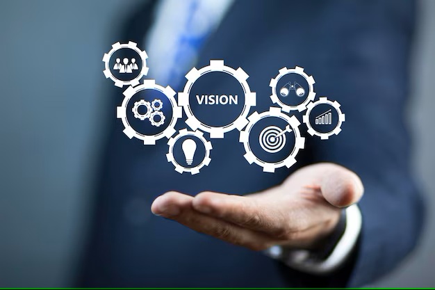 a man in a suit holding a white icon with the words vision